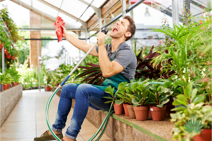 man singing in a greenhouse